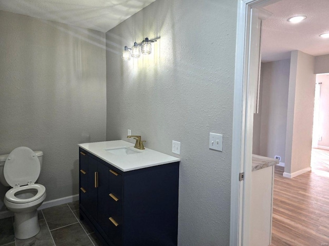 bathroom featuring vanity, toilet, and wood-type flooring