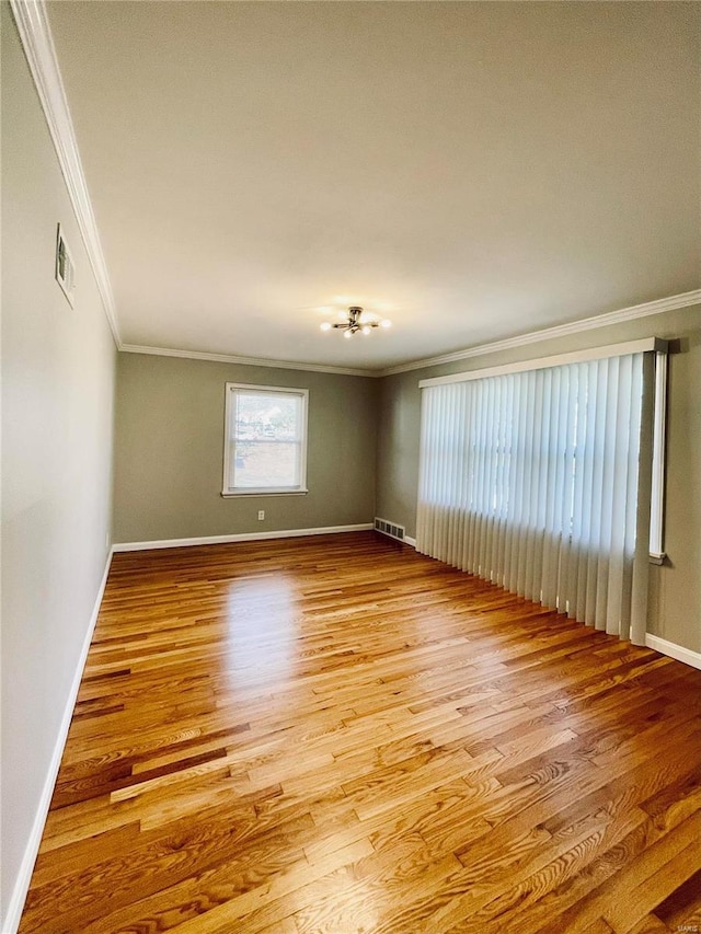 unfurnished room with light hardwood / wood-style flooring and ornamental molding