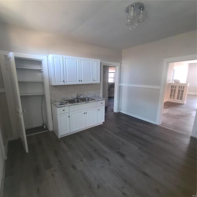 kitchen featuring white cabinets, plenty of natural light, dark wood-type flooring, and sink