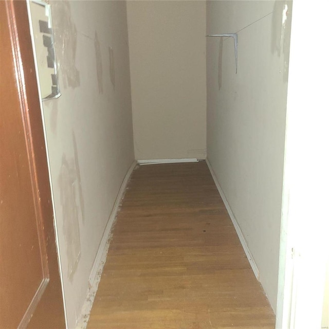 corridor with light hardwood / wood-style flooring