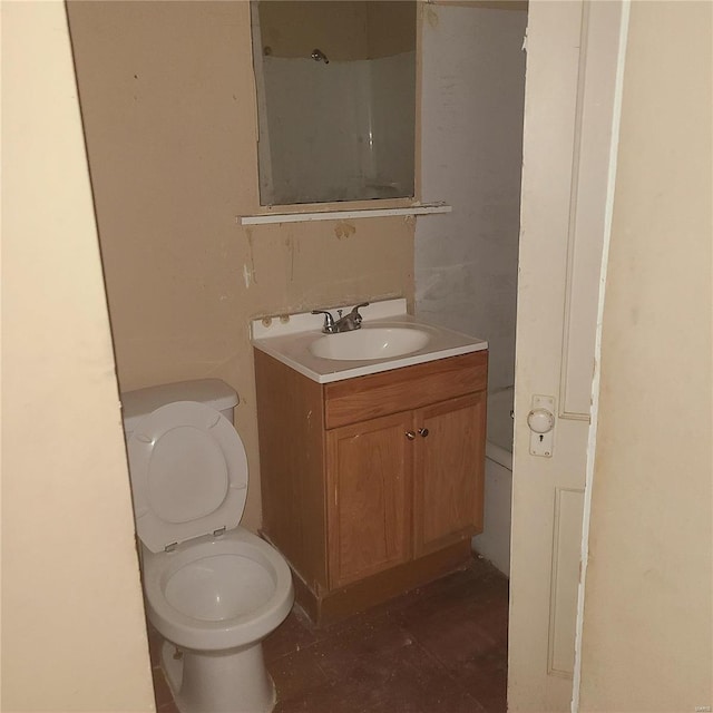 bathroom with tile patterned flooring, vanity, and toilet