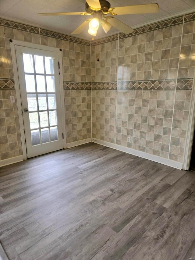 spare room featuring hardwood / wood-style floors and ceiling fan