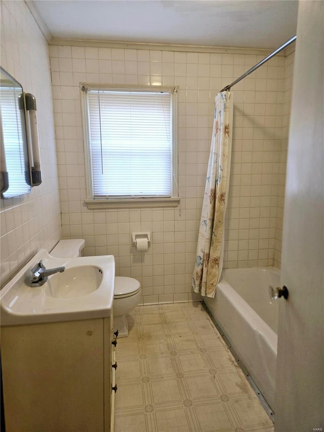 full bathroom featuring vanity, toilet, tile walls, and crown molding