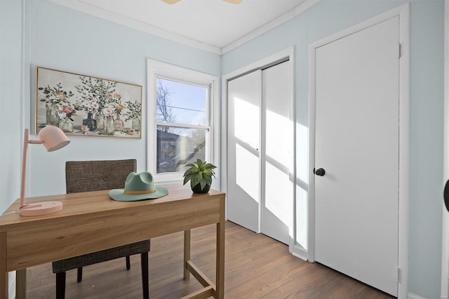 home office with wood-type flooring and ornamental molding