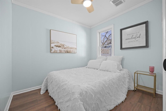 bedroom featuring ornamental molding, ceiling fan, and dark wood-type flooring