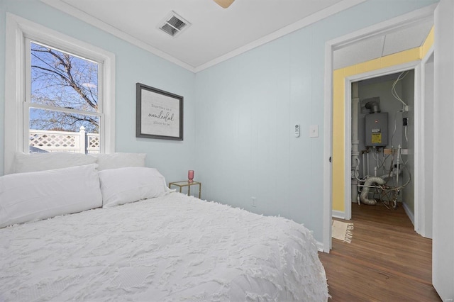 bedroom with dark hardwood / wood-style flooring, ceiling fan, ornamental molding, and water heater