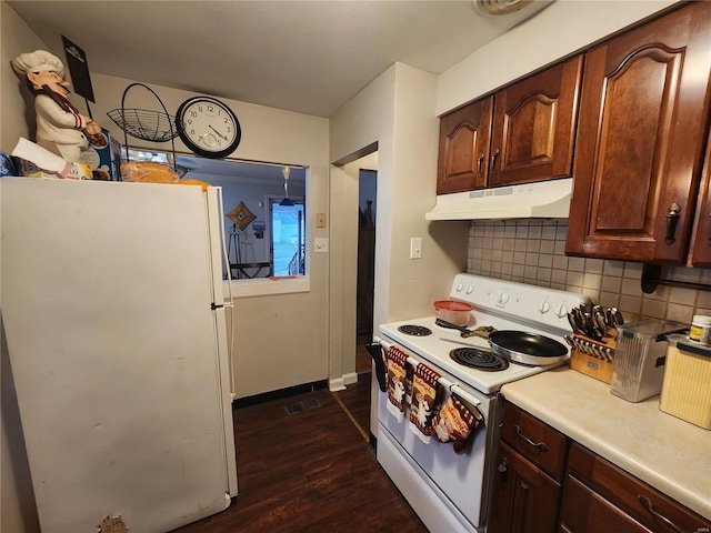 kitchen featuring white appliances, dark hardwood / wood-style floors, and backsplash