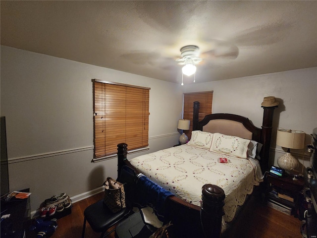 bedroom featuring dark hardwood / wood-style floors and ceiling fan