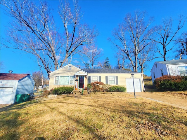 single story home with a garage, concrete driveway, and a front yard