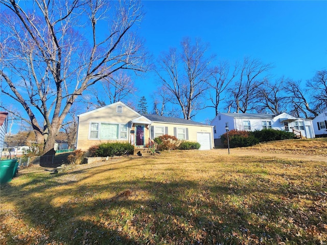 ranch-style house with a garage, a front yard, and fence