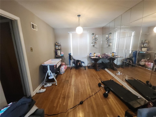 dining room with visible vents, baseboards, and wood finished floors