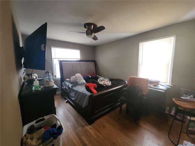 bedroom with dark wood-style floors and ceiling fan