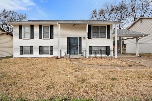 bi-level home featuring a front yard and a carport