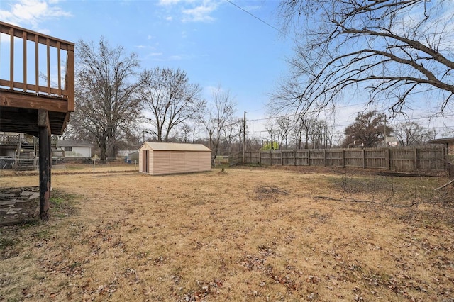 view of yard featuring a storage unit and a wooden deck