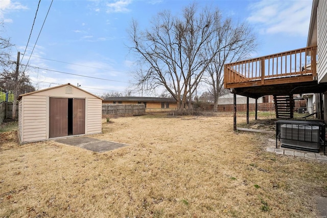 view of yard with a storage unit and a wooden deck