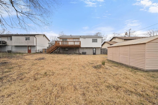 rear view of house featuring a storage shed, a yard, a wooden deck, and central air condition unit