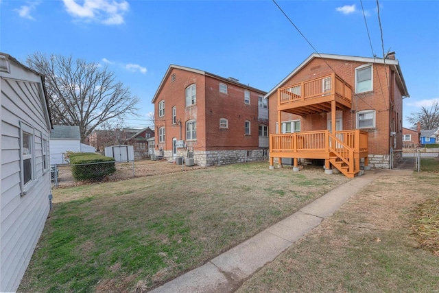 back of house featuring central air condition unit, a balcony, a deck, and a lawn