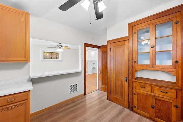 kitchen featuring ceiling fan and light wood-type flooring