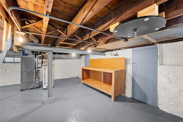 basement featuring gas water heater and heating unit