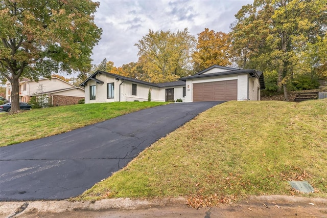 view of front of property with a garage and a front lawn