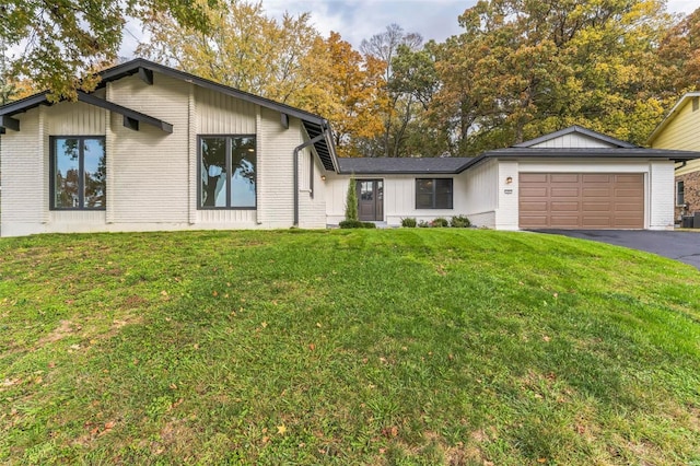 single story home with a front lawn and a garage