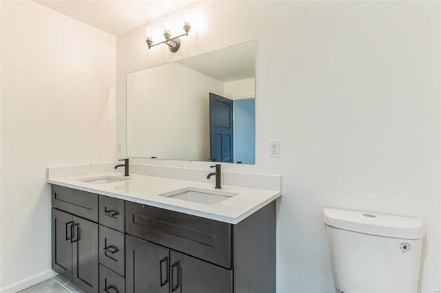 bathroom featuring toilet, vanity, and tile patterned floors