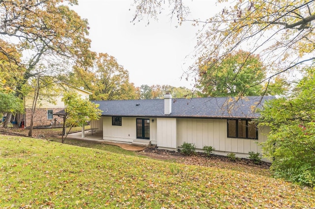 rear view of property featuring a yard and a patio