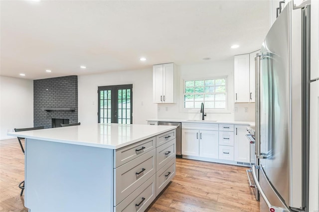 kitchen featuring a center island, white cabinets, french doors, and appliances with stainless steel finishes