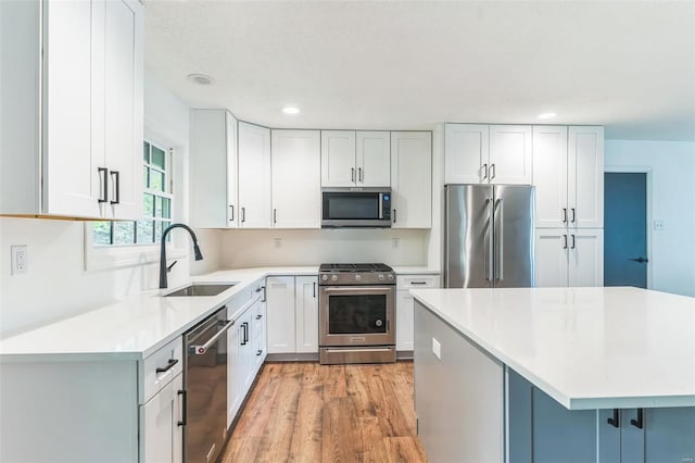 kitchen with sink, white cabinets, and stainless steel appliances