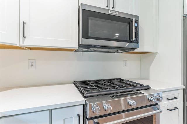 kitchen featuring white cabinets and appliances with stainless steel finishes