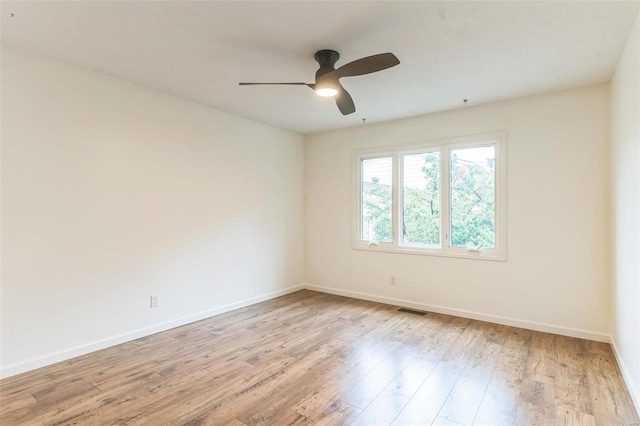 empty room with light hardwood / wood-style flooring and ceiling fan