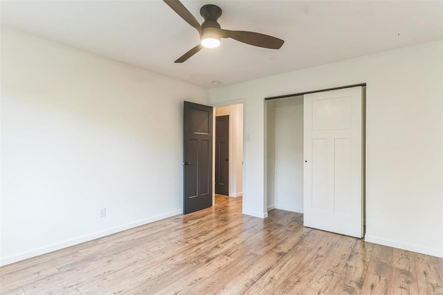 unfurnished bedroom featuring ceiling fan, light wood-type flooring, and a closet