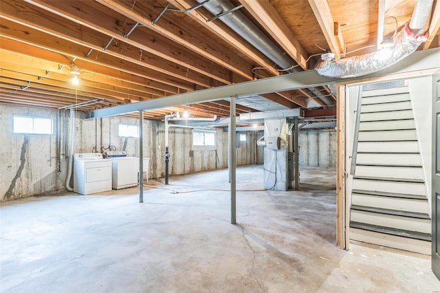 basement featuring a wealth of natural light and washer and dryer