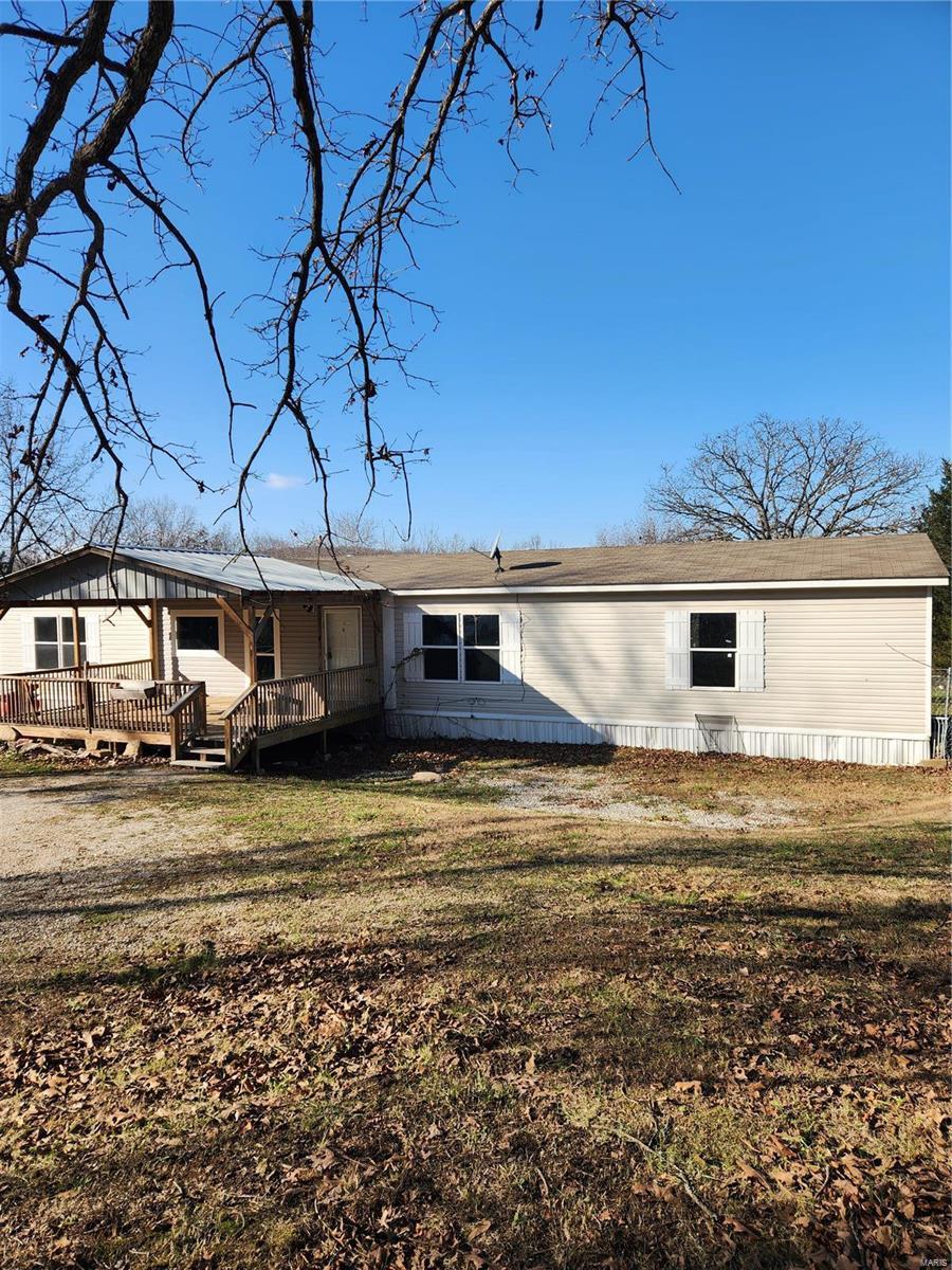 back of property featuring a yard