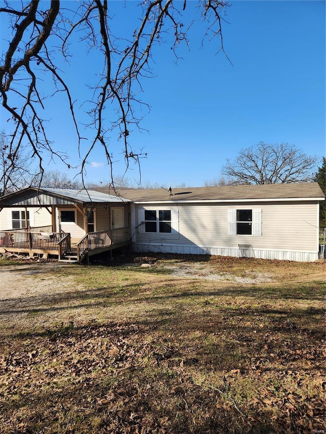 back of property featuring a yard