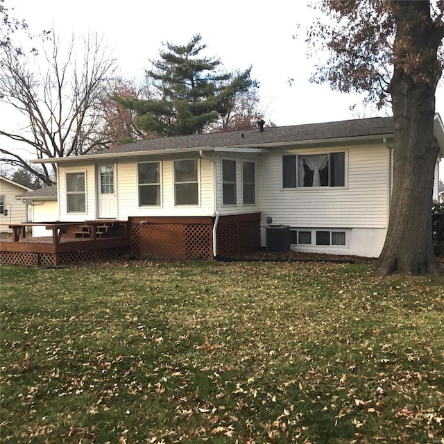 back of property featuring a yard, central air condition unit, and a wooden deck