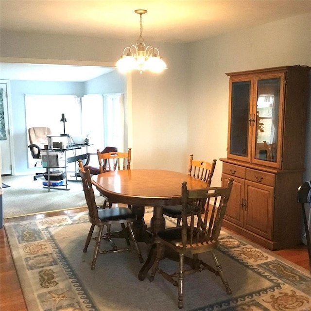 dining space featuring a chandelier and wood-type flooring