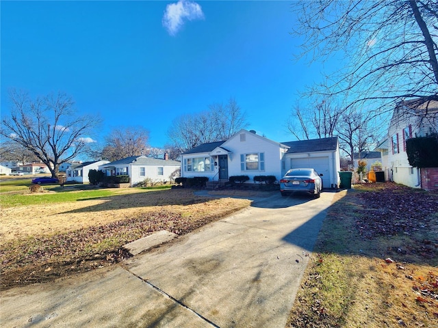 exterior space with driveway, an attached garage, and a residential view