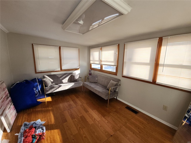 sitting room with visible vents, baseboards, and wood finished floors