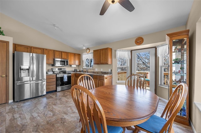 dining area with lofted ceiling and baseboards