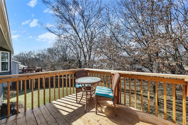 wooden terrace with a lawn