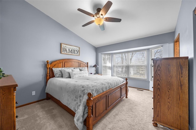 bedroom with visible vents, ceiling fan, baseboards, light colored carpet, and vaulted ceiling