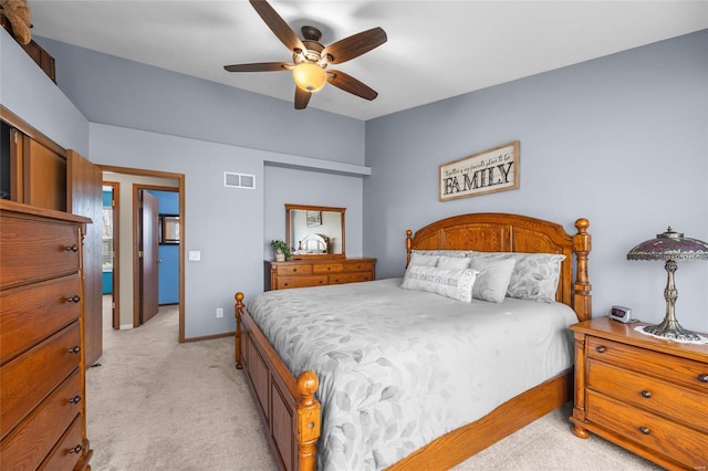 bedroom with visible vents, baseboards, light colored carpet, and ceiling fan