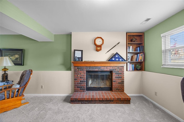 living area with visible vents, a fireplace, baseboards, and carpet