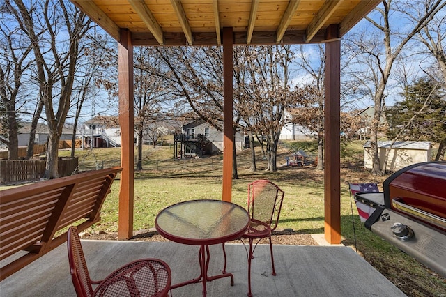 wooden terrace with a patio and a yard