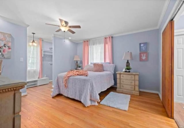 bedroom with ceiling fan, light hardwood / wood-style flooring, ornamental molding, and a closet