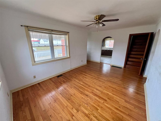 empty room with light hardwood / wood-style floors and ceiling fan