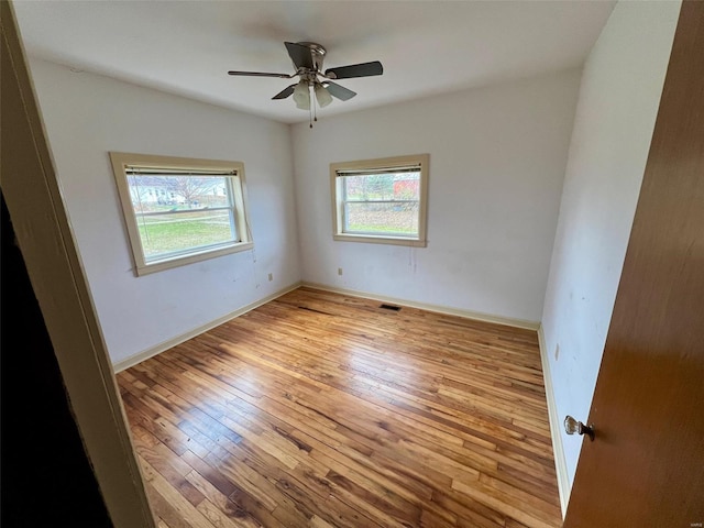 unfurnished room featuring light wood-type flooring and ceiling fan