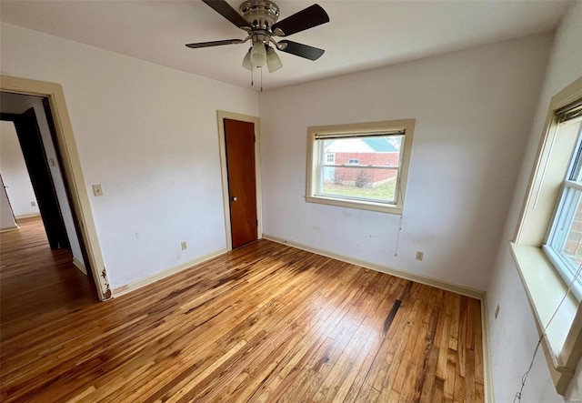 spare room featuring light hardwood / wood-style floors and ceiling fan