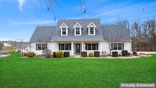 new england style home with covered porch and a front yard